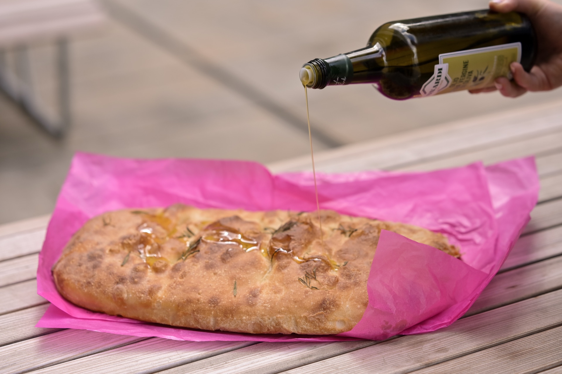Olive oil being poured on focaccia