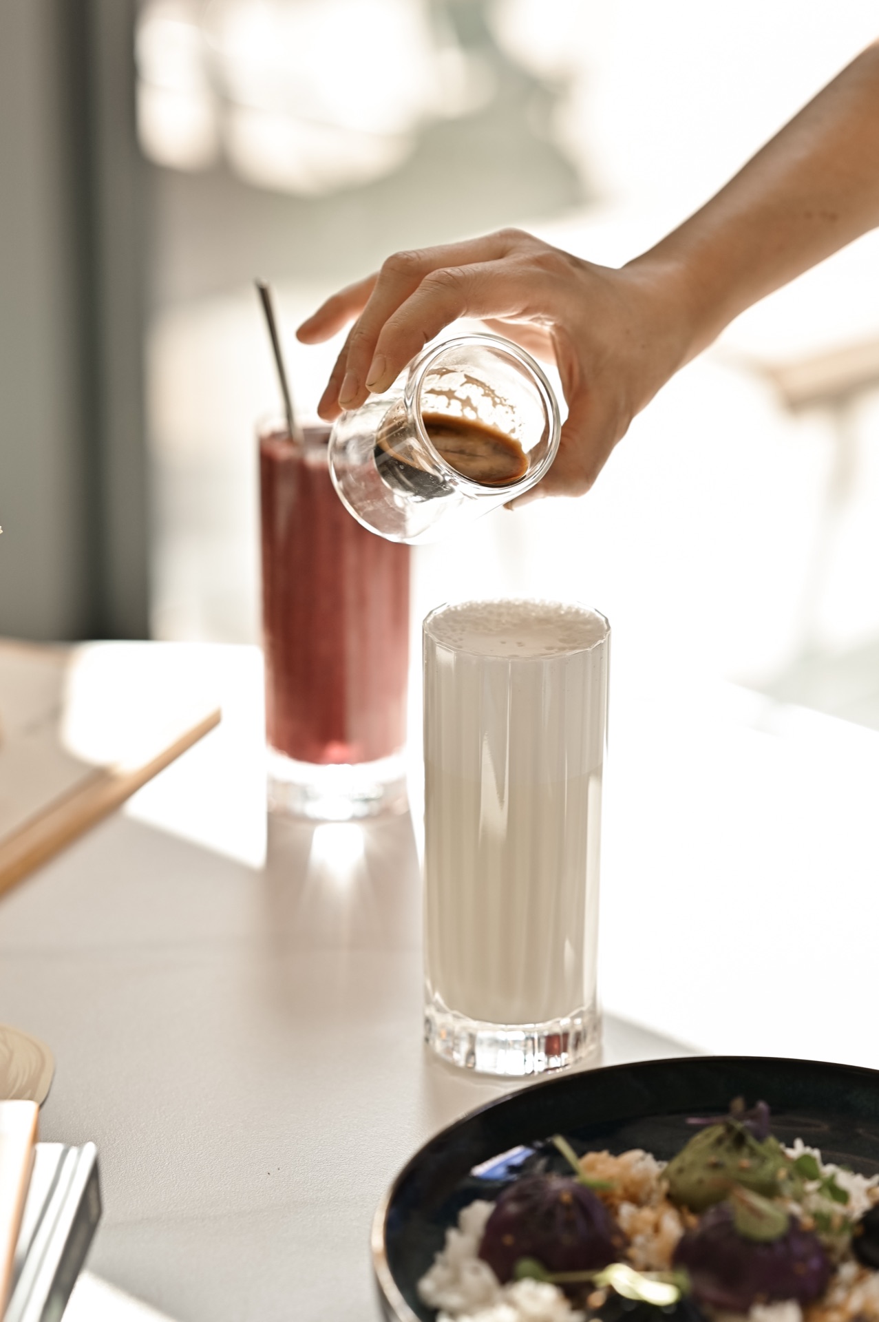 Pouring espresso into iced latte